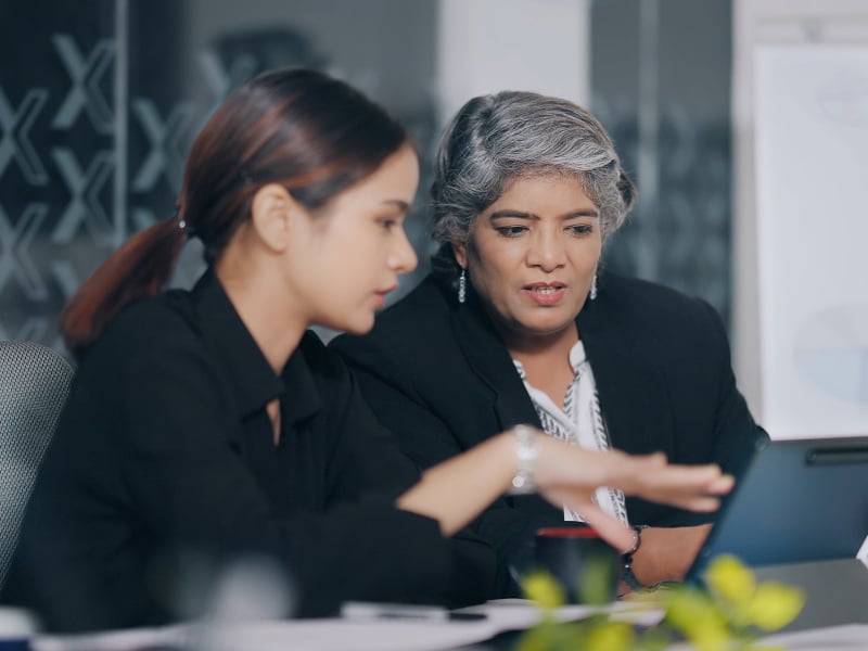 coworkers look at computer together