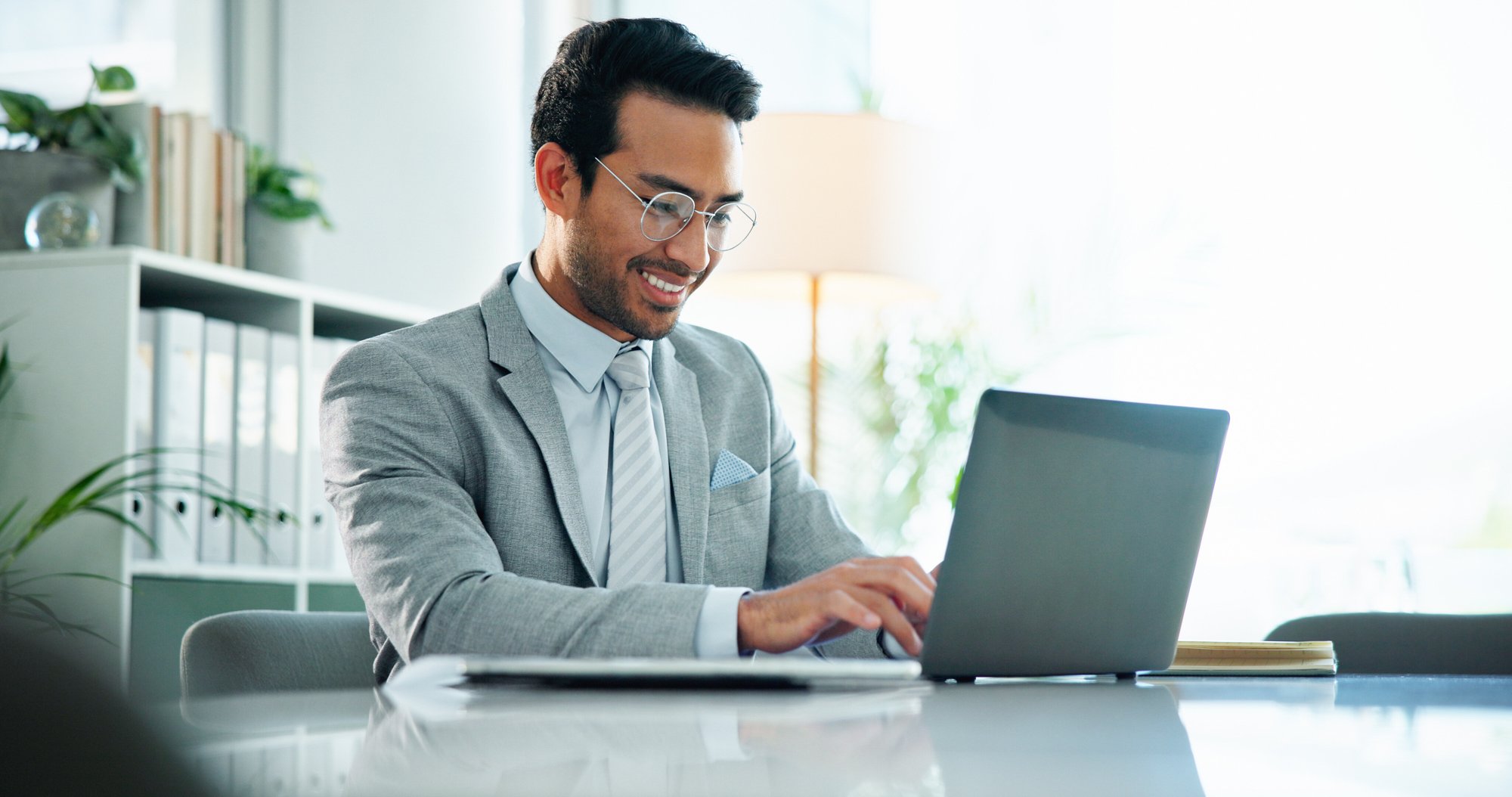 typing-laptop-and-smile-with-business-man-in-offi-2024-12-14-04-43-39-utc