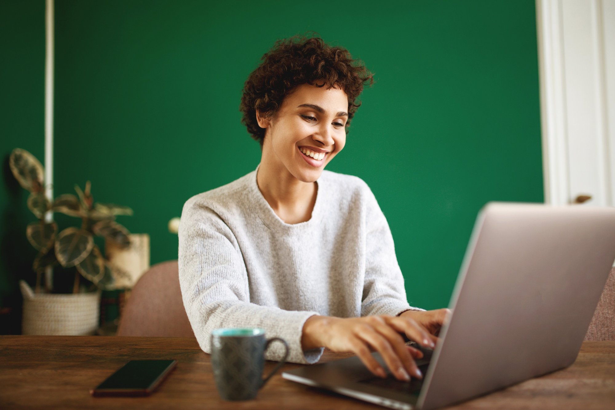 young-african-american-woman-typing-with-laptop-co-2024-10-14-22-55-12-utc