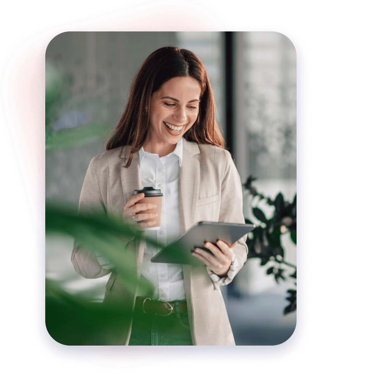 woman smiling while looking at tablet