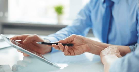 Professional reviewing data on a tablet