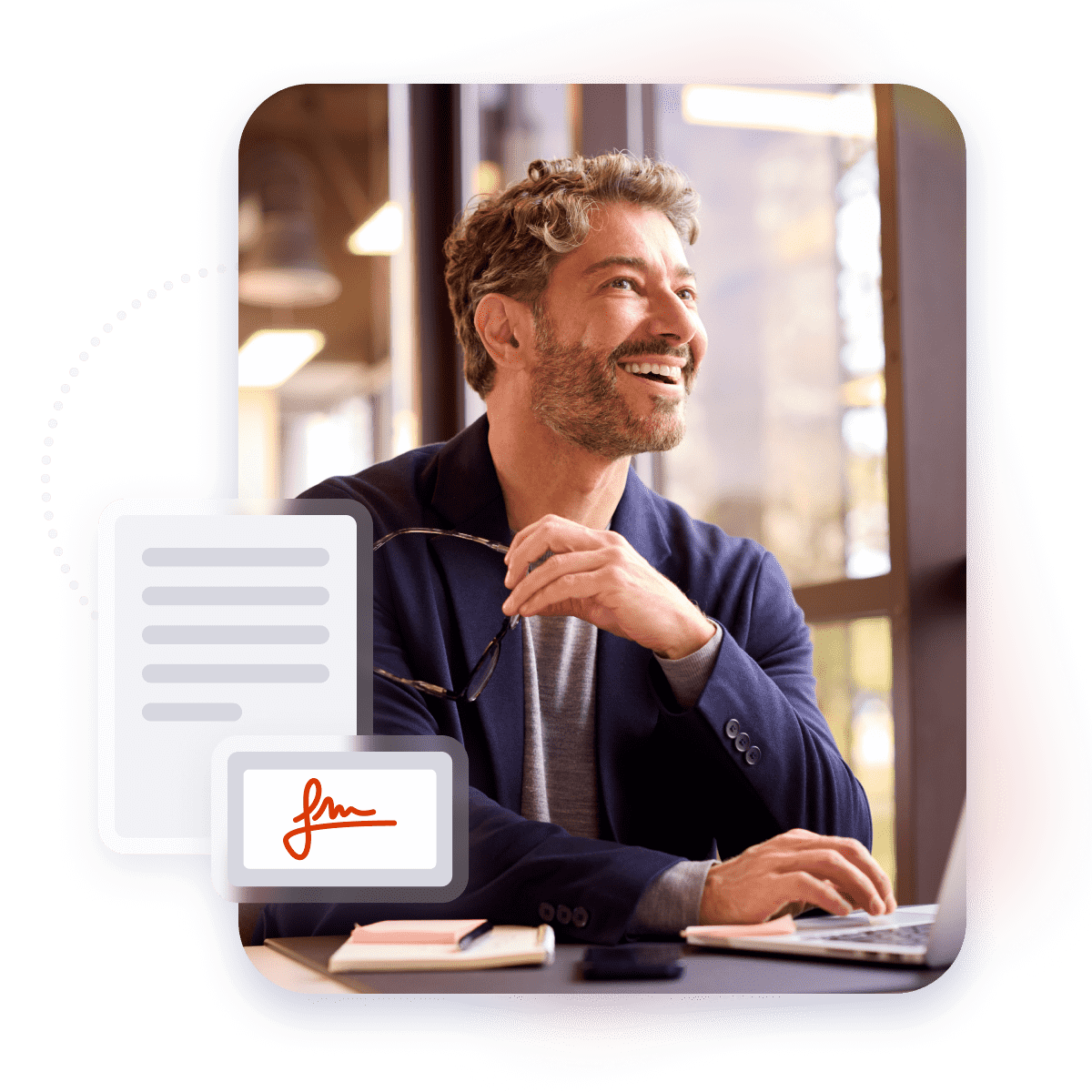 Happy man working with laptop and glasses in hand