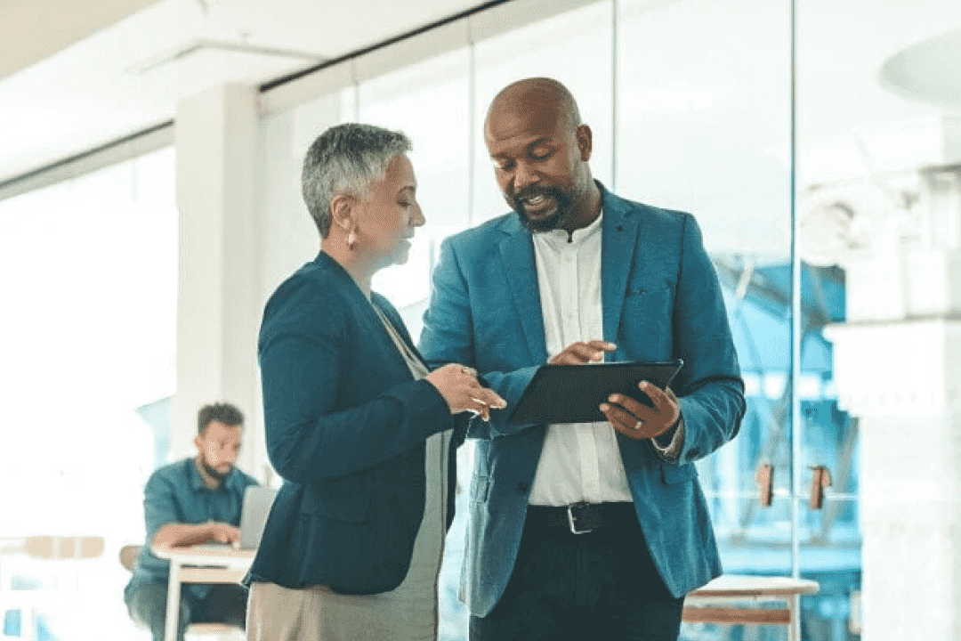 Business colleagues having a chat while using a tablet