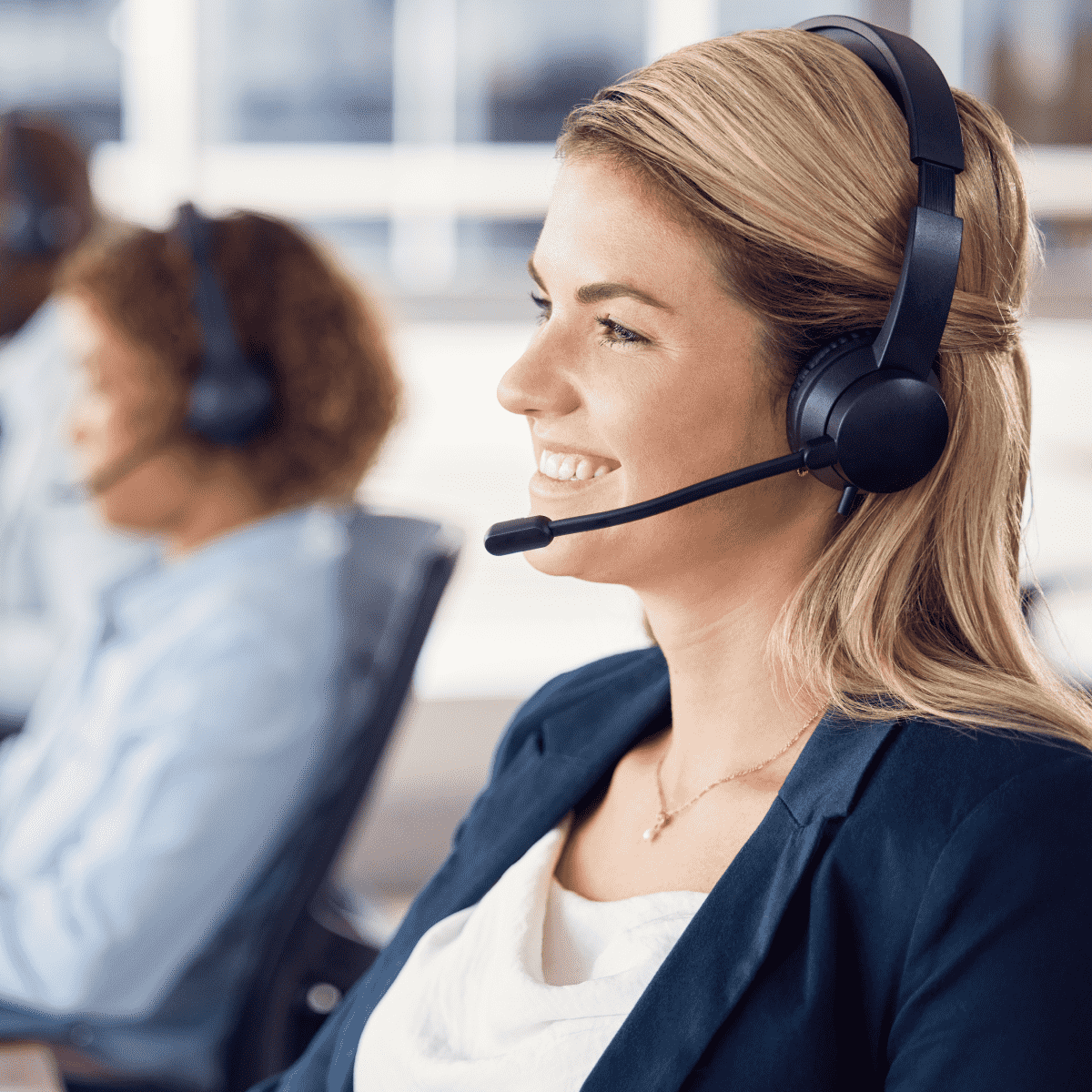 Customer support woman smiling while wearing a headphone set